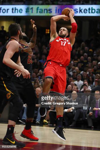 Jonas Valanciunas of the Toronto Raptors takes a shot over LeBron James of the Cleveland Cavaliers during the first half of Game Three of the Eastern...