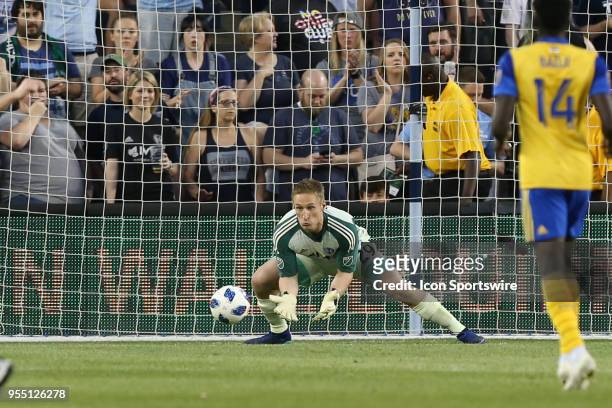 Sporting Kansas City goalkeeper Tim Melia smothers a save in the first half of an MLS match between the Colorado Rapids and Sporting Kansas City on...