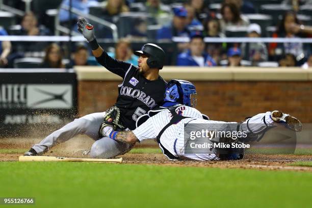 Noel Cuevas of the Colorado Rockies is tagged out at home by Tomas Nido of the New York Mets trying to score on David Dahl single in the ninth inning...