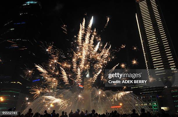 Fireworks explode next to Jakarta landmark Welcome Statue during the New Year 2010 celebrations in Jakarta on January 1, 2009. People around the...