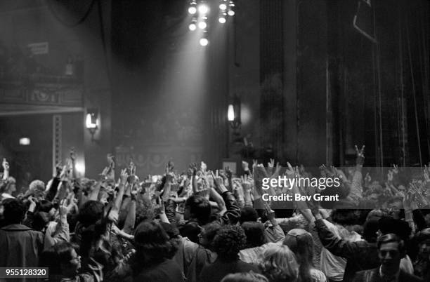 View of people, many holding up 'V' signs with their fingers, at the Filmore East during the venue's takeover by anarchist groups, the Family and Up...