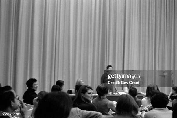 View over the audience in the Time Life Building auditorium as a panel speaker stands during an employee-organized meeting to support the Moratorium...