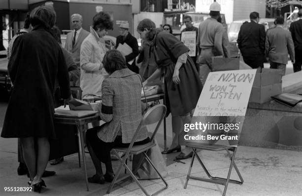 Outside the Time Life Building during the Moratorium to End the War in Vietnam demonstration, a woman with a black armband over her blazer staffs a...