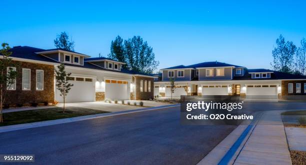 suburb houses at dusk - garage driveway stock pictures, royalty-free photos & images