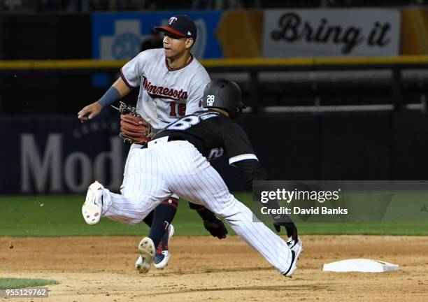 Leury Garcia of the Chicago White Sox steals second base as Ehire Adrianza of the Minnesota Twins waits for the throw during the seventh inning on...