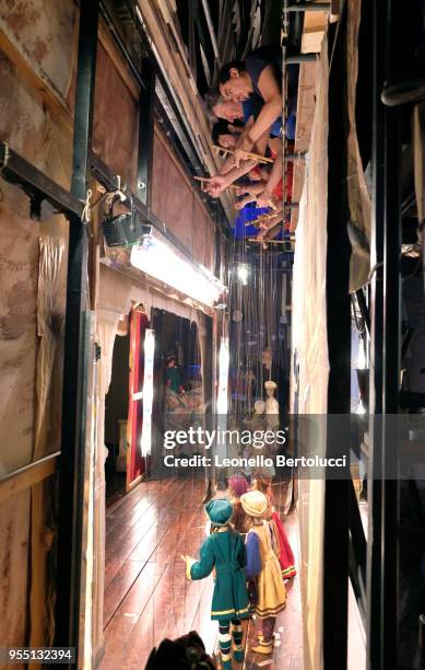 The puppeteers working behind the scenes during the show "Lamp of Aladdin" at the theater of the "Carlo Colla and Sons Marionette Company" on March...