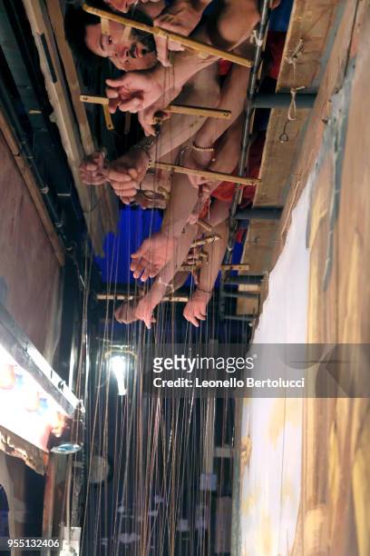 The puppeteers working behind the scenes during the show "Lamp of Aladdin" at the theater of the "Carlo Colla and Sons Marionette Company" on March...