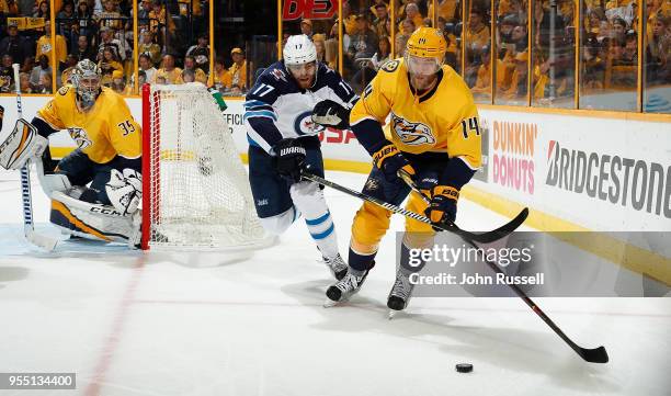 Mattias Ekholm of the Nashville Predators skates against Adam Lowry of the Winnipeg Jets in Game Five of the Western Conference Second Round during...