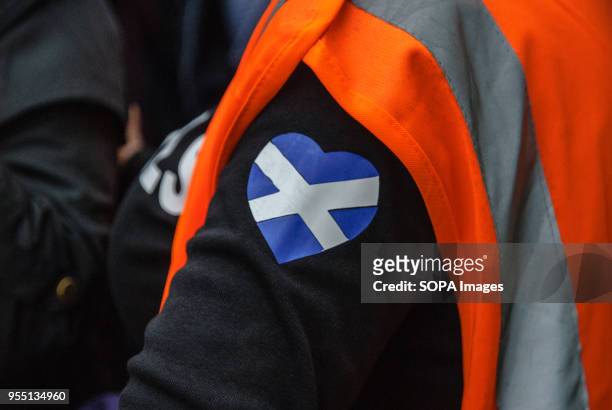 Patch of the Scottish Flag in the shape of a heart on a steward's jumper during the protest. Thousands of Scottish independence supporters marched...
