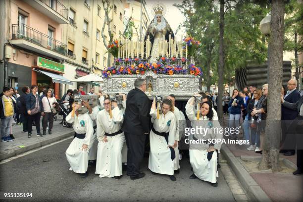 Group of brothers of the 15 + 1 Brotherhood carry during the procession the May Cross the statue of the Virgin of the Remedies. The 15 + 1...
