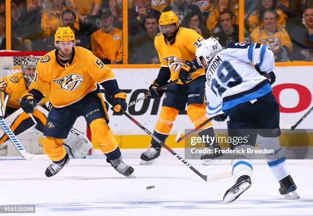 Toby Enstrom of the Winnipeg Jets takes a shot toward Austin Watson nas P.K. Subban of the Nashville Predators during the first period of Game Five...