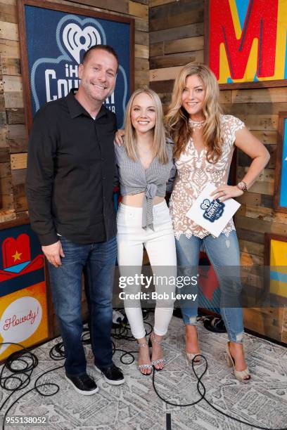 Danielle Bradbery poses with radio personalities Billy Greenwood and Anne Hudson backstage at the 2018 iHeartCountry Festival By AT&T at The Frank...