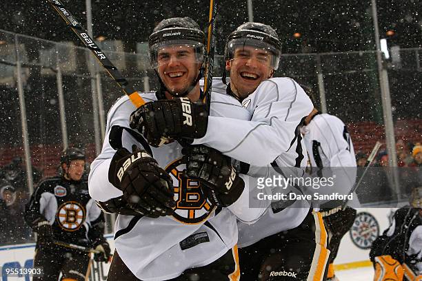 David Krejci and Blake Wheeler of the Boston Bruins joke around as they skate during practice prior to Bridgestone's presentation of 2010 NHL Winter...