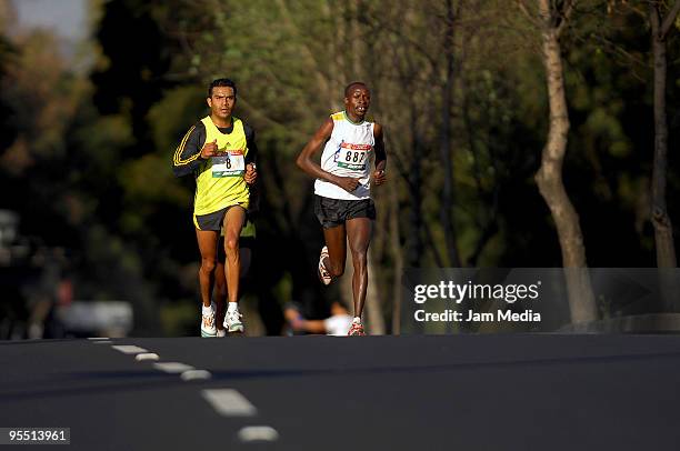 Teodoro Vega from Mexico and Rotich Chemerisia Samuel from Kenya in action during the San Silvestre Road Race at the Reforma Avenue on December 31,...