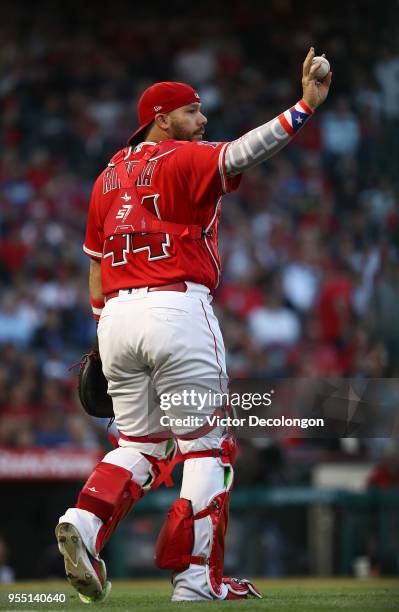 Catcher Rene Rivera of the Los Angeles Angels of Anaheim holds up the ball in the seventh inning during the MLB game against the New York Yankees at...