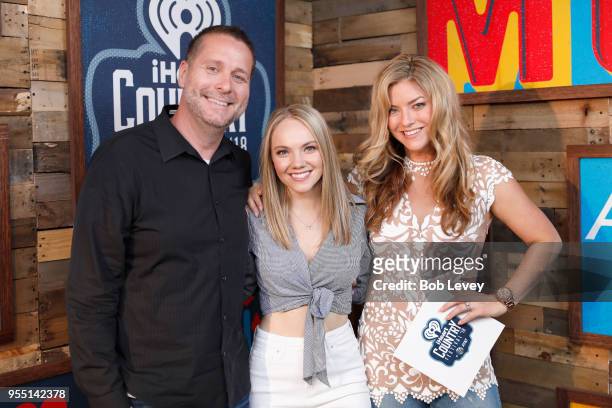 Danielle Bradbery poses with radio personalities Billy Greenwood and Anne Hudson backstage at the 2018 iHeartCountry Festival By AT&T at The Frank...