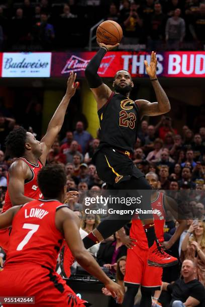 LeBron James of the Cleveland Cavaliers hits the game winning shot over the outstretched hand of OG Anunoby of the Toronto Raptors to win Game Three...