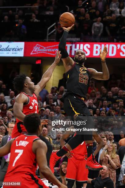 LeBron James of the Cleveland Cavaliers hits the game winning shot over the outstretched hand of OG Anunoby of the Toronto Raptors to win Game Three...