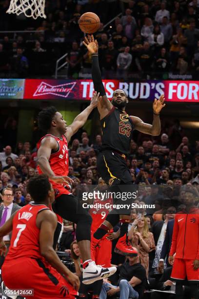 LeBron James of the Cleveland Cavaliers hits the game winning shot over the outstretched hand of OG Anunoby of the Toronto Raptors to win Game Three...