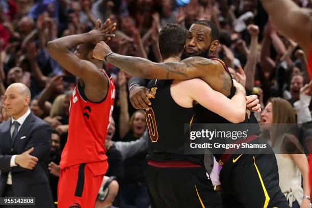 LeBron James of the Cleveland Cavaliers celebrates his game winning shot with Kevin Love next to Serge Ibaka of the Toronto Raptors during Game Three...