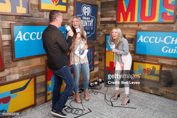 Radio personality Billy Greenwood, radio personality Anne Hudson, and Danielle Bradbery speak backstage at the 2018 iHeartCountry Festival By AT&T at...