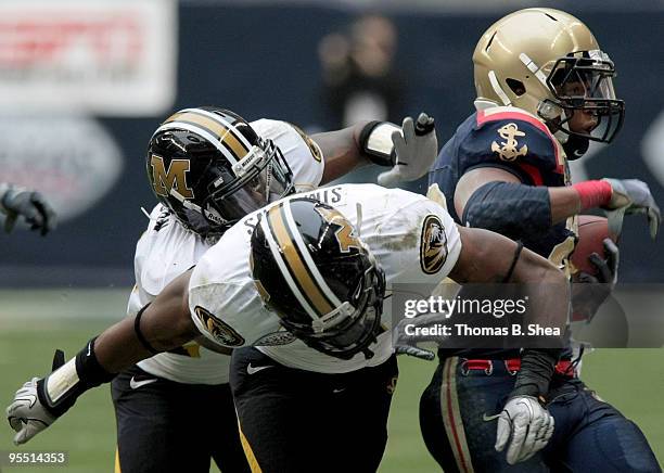 The defense of the Missouri Tigers tackles quarterback Ricky Dobbs of the Navy Shipmen from crossing the goal lineduring the Texas Bowl at Reliant...
