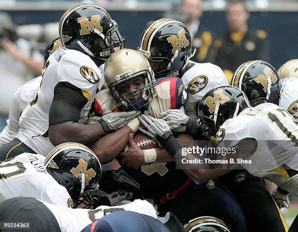 The defense of the Missouri Tigers stops quarterback Ricky Dobbs of the Navy Shipmen from crossing the goal line during the Texas Bowl at Reliant...