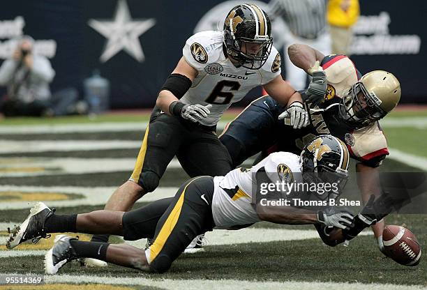 Defensive back Kevin Rutland of the Missouri Tigers jumps on the ball after quarterback Ricky Dobbs of the Navy Shipmen fumbles the ball over the...