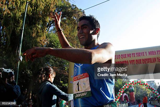 Juan Luis Barrios of Mexico wins the San Silvestre Road Race at the Reforma Avenue on December 31, 2009 in Mexico City, Mexico. Mexico's race...