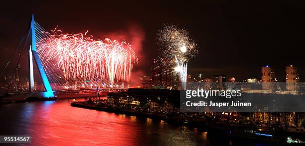 New Year's Eve fireworks display illuminates the sky over the Erasmus Bridge crossing the Nieuwe Maas river on January 1, 2010 in Rotterdam, The...