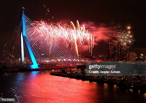 New Year's Eve fireworks display illuminates the sky over the Erasmus Bridge crossing the Nieuwe Maas river on January 1, 2010 in Rotterdam, The...