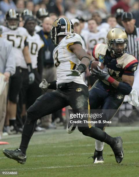 Running back Marcus Curry of the Navy Shipmen makes a catch against cornerback Jasper Simmons of the Missouri Tigers after the Texas Bowl at Reliant...