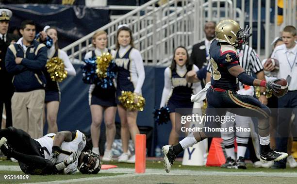 Running back Marcus Curry of the Navy Shipmen scores a touchdown against the Missouri Tigers after the Texas Bowl at Reliant Stadium on December 31,...