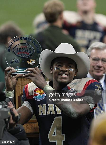 Quarterback Ricky Dobbs of the Navy Shipmen holds up the Texas Bowl MVP Trophy after the Texas Bowl at Reliant Stadium on December 31, 2009 in...