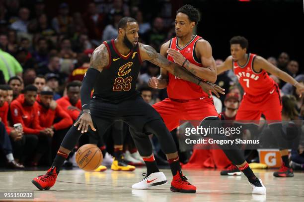 LeBron James of the Cleveland Cavaliers battles with DeMar DeRozan of the Toronto Raptors during the second half in Game Three of the Eastern...