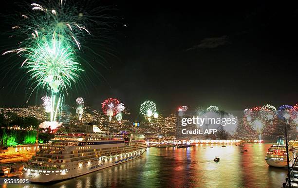 Fireworks light up the sky over Funchal Bay on Madeira Island early on Januray 1, 2010 in celebration of New Year's Day. Revellers rang in the New...