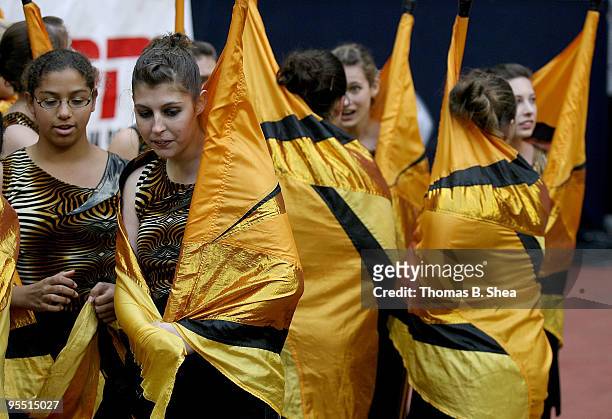 Members of Missouri Tigers Color Guard wrap them selves in their flags to stay warm before half time as the the Navy Shipmen played against the...