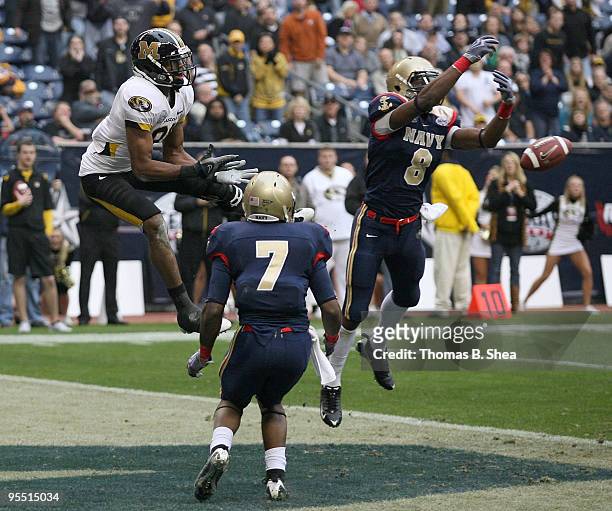Safety Wyatt Middleton of the Navy Shipmen breaks up a pass for wide receiver Danario Alexanader of the Missouri Tigers during the Texas Bowl at...