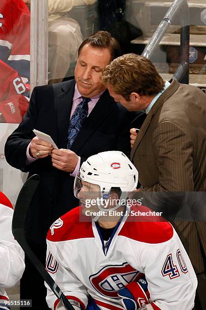 Head Coach Jacques Martin of the Montreal Canadiens chats with Assistant Coach Kirk Muller during a break in the action against the Florida Panthers...