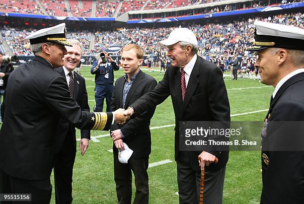 Navy Admiral Jeff Fowler shakes hands with former President George W. Bush Sr. Before the Texas Bowl at Reliant Stadium on December 31, 2009 in...