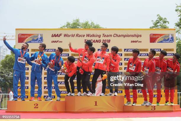 Runner-up team Italy, winner team Japan and third place team China take a selfie during medal ceremony of Men's 20 kilometres Race Walk of IAAF World...