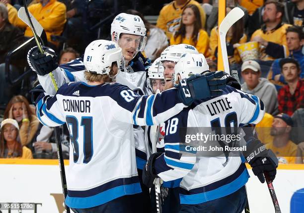 Kyle Connor celebrates a goal with Nikolaj Ehlers, Tyler Myers and Bryan Little of the Winnipeg Jets against the Nashville Predators in Game Five of...