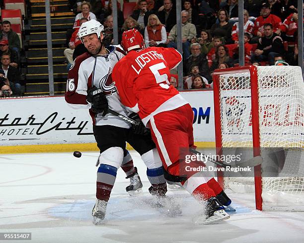 Darcy Tucker of the Colorado Avalanche gets tied up in front of the net by Nicklas Lidstrom of the Detroit Red Wings during an NHL game at Joe Louis...