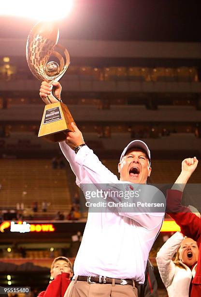 Head coach Paul Rhoads of the Iowa State Cyclones celebrates with the Insight Bowl trophy after defeating the Minnesota Golden Gophers at Arizona...
