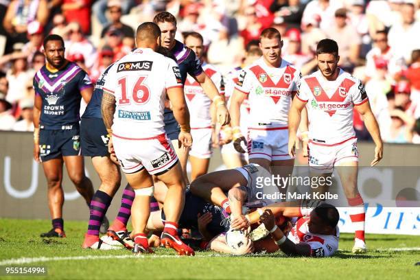 Cameron Munster of the Storm is tackled short of the try line during the round nine NRL match between the St George Illawarra Dragons and the...