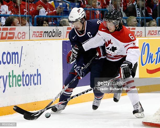 Derek Stepan of Team USA skates with the puck while being defended by Ryan Ellis of Team Canada during the 2010 IIHF World Junior Championship...