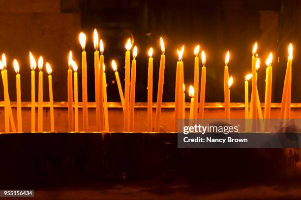 lite candles in church of the holy sepulchre. - orthodox stock pictures, royalty-free photos & images