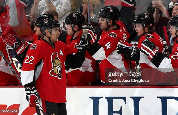 Chris Kelly of the Ottawa Senators celebrates his goal with teammates Chris Phillips and Erik Karlsson in a game against the New York Islanders at...