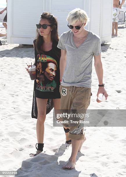 Tom Felton and his girlfriend are seen on Miami Beach on December 31, 2009 in Miami, Florida.