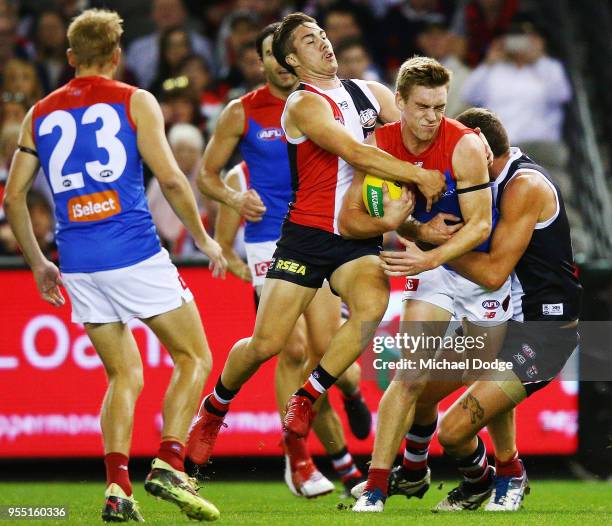 Jade Gresham of the Saints tackles Oscar McDonald of the Demons during the round seven AFL match between St Kilda Saints and the Melbourne Demons at...